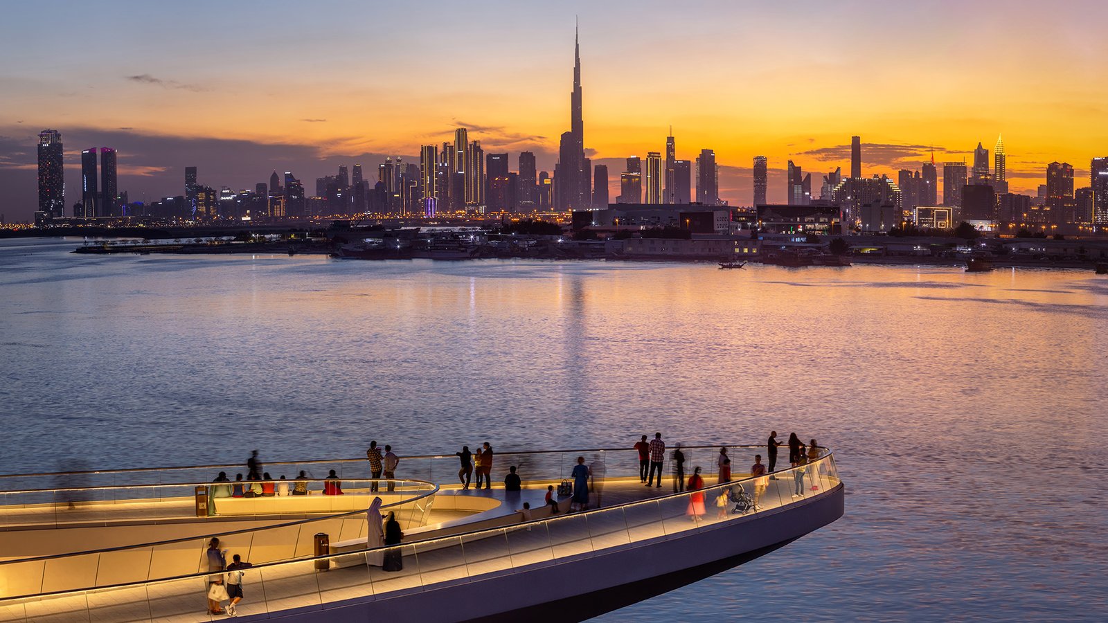 Creek Marina promenade with the Downtown Dubai skyline at sunset